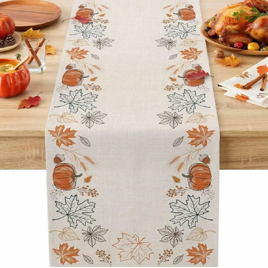 Pumpkin and maple table runner on a wooden table