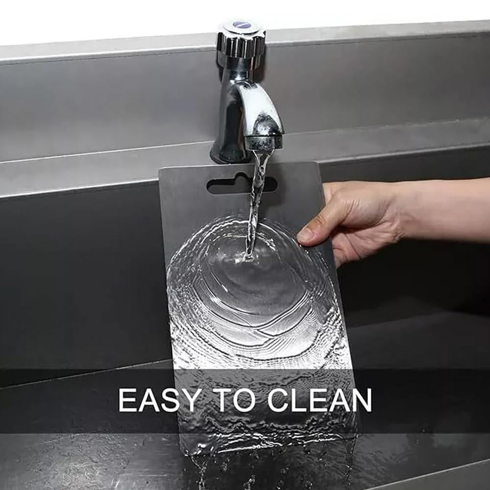 Rinsing the stainless steel board under the tap